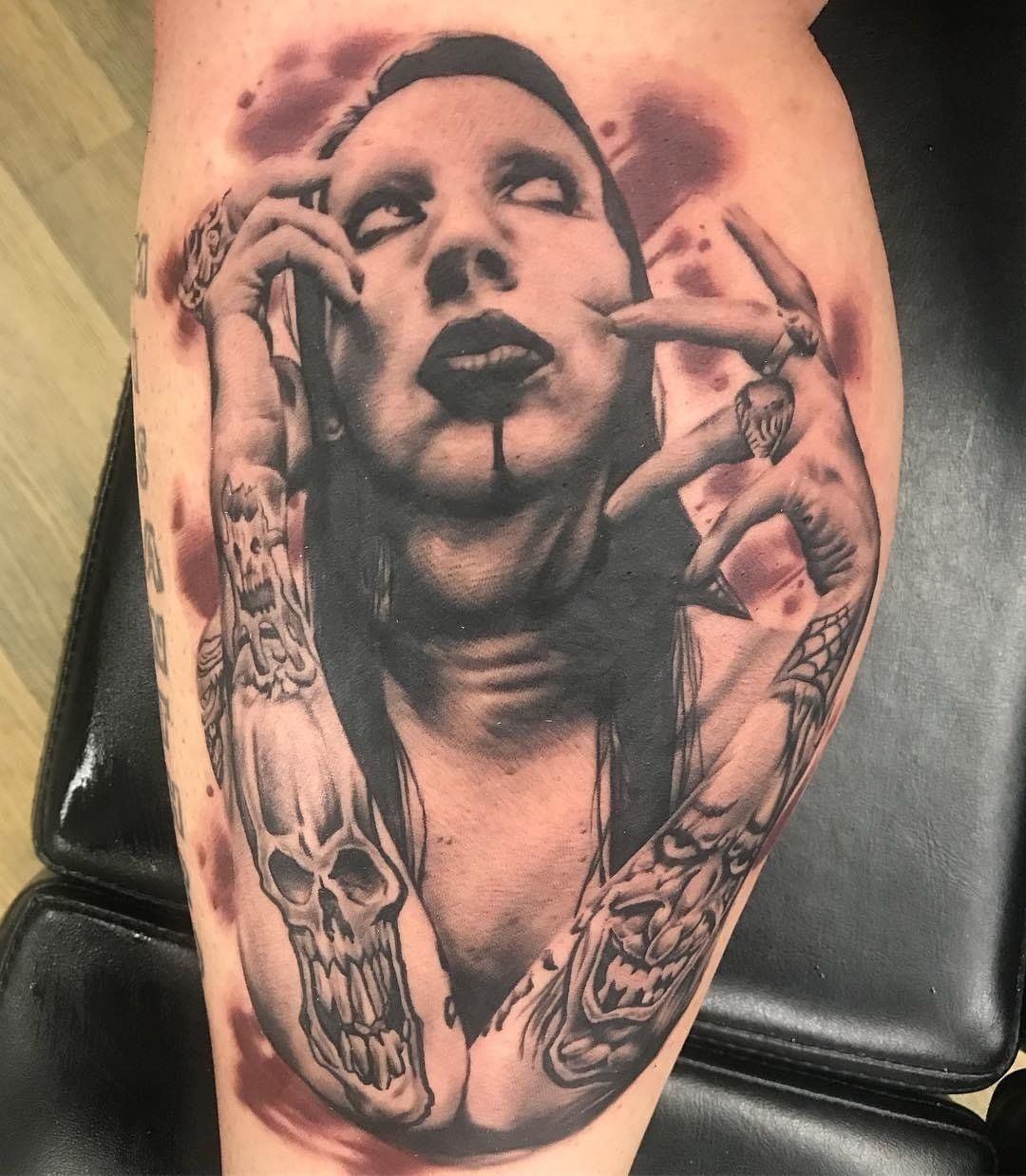 A tattoo of marilyn manson on a person 's leg