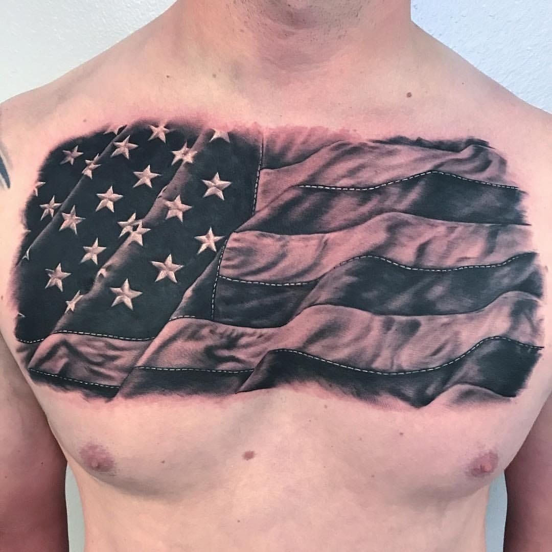 A man has an american flag tattoo on his chest