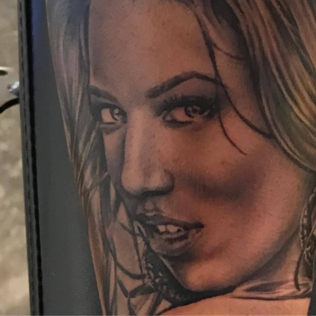 A close up of a tattoo of a woman 's face