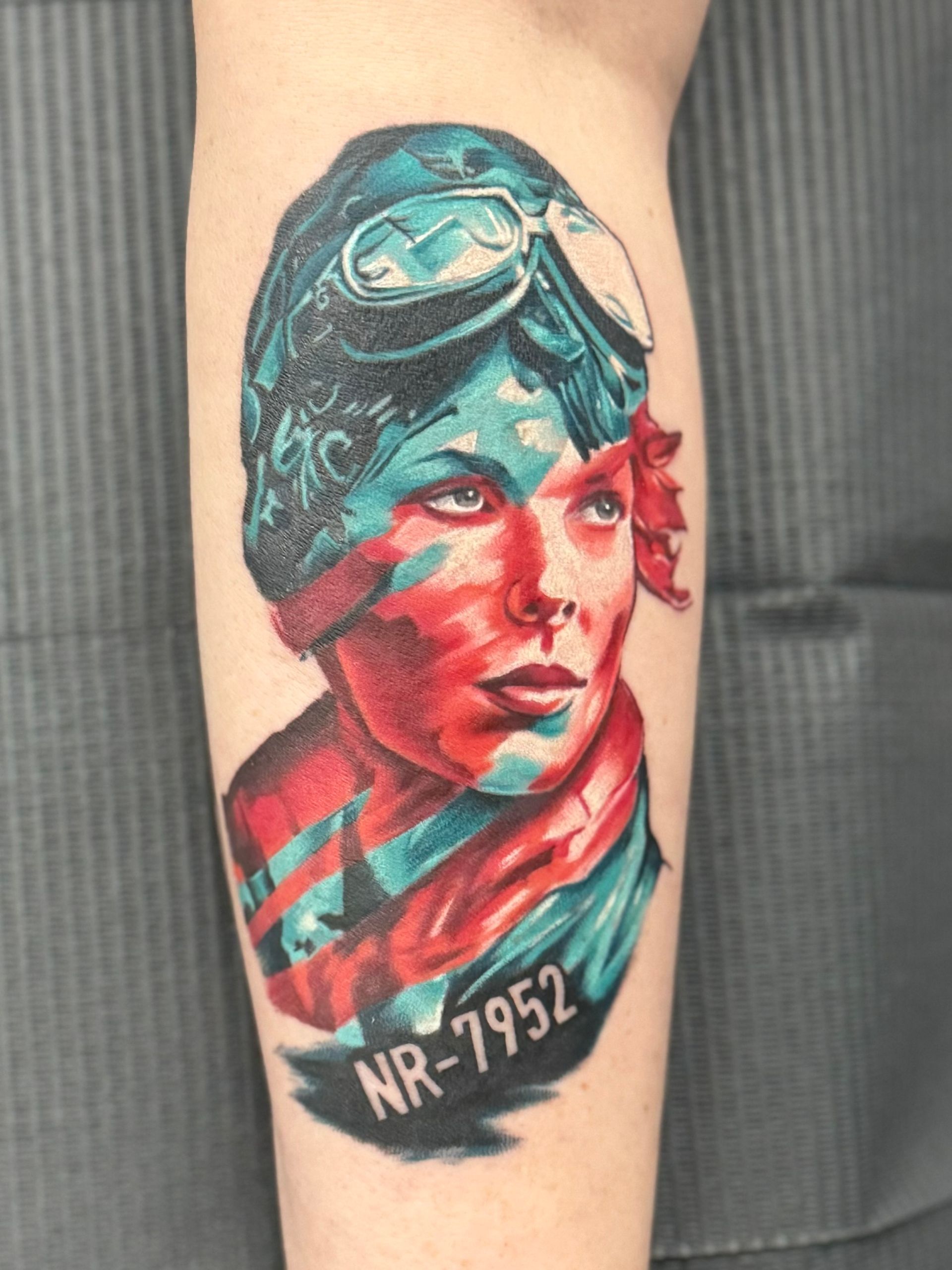 Red and blue tattoo of amelia Earhart.