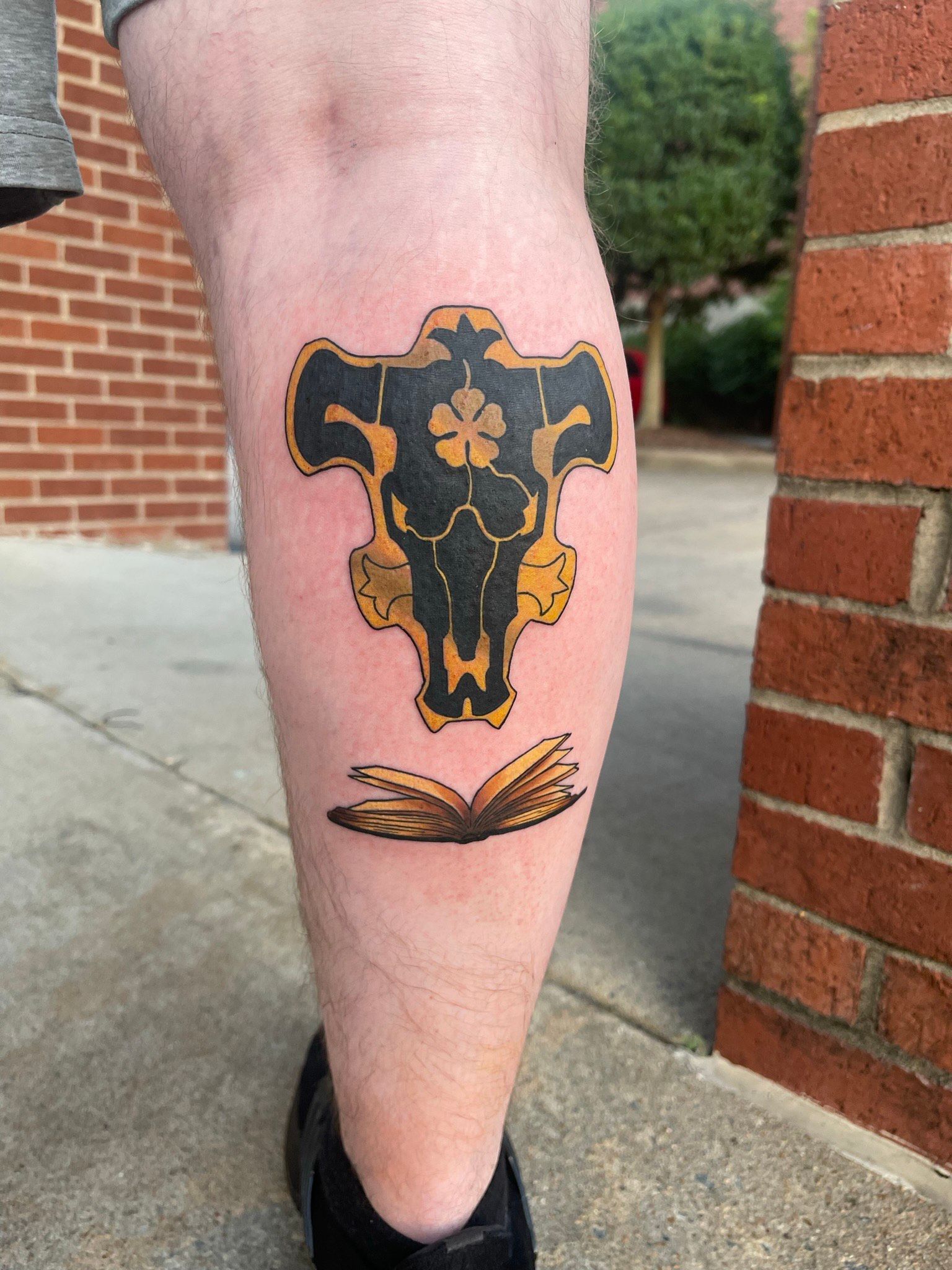 A person has a tattoo of a ram 's skull on their leg.