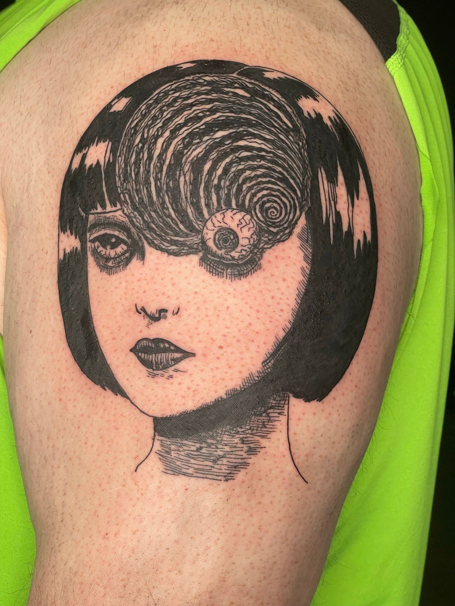 A person has a tattoo of a woman 's face on their arm.