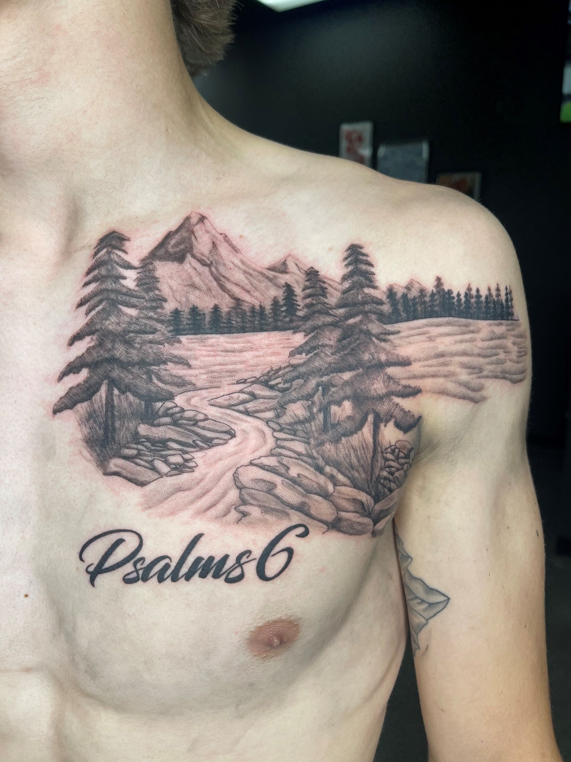 A man has a psalms 6 tattoo on his chest