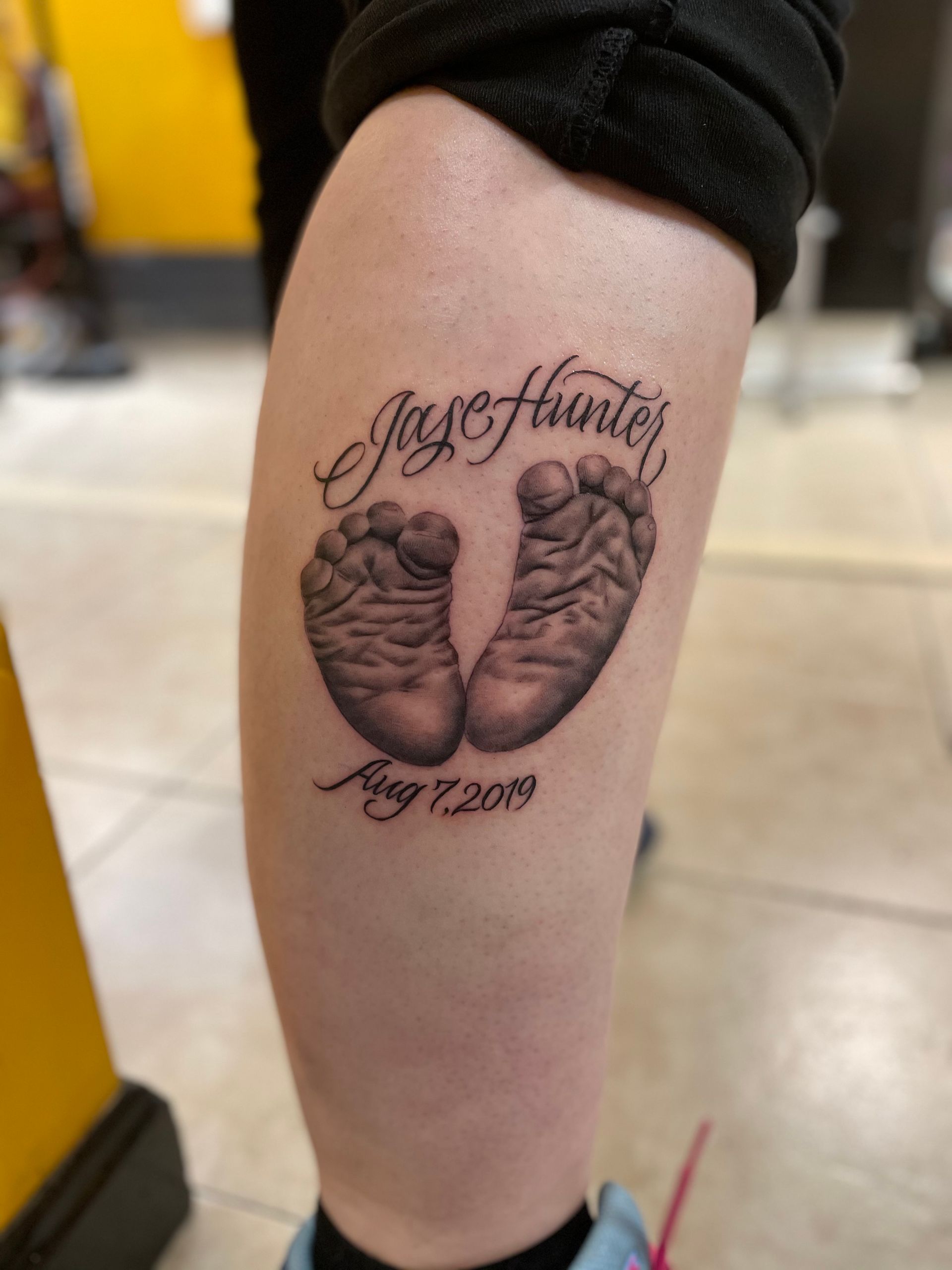 A person has a tattoo on their leg that says jay hunter