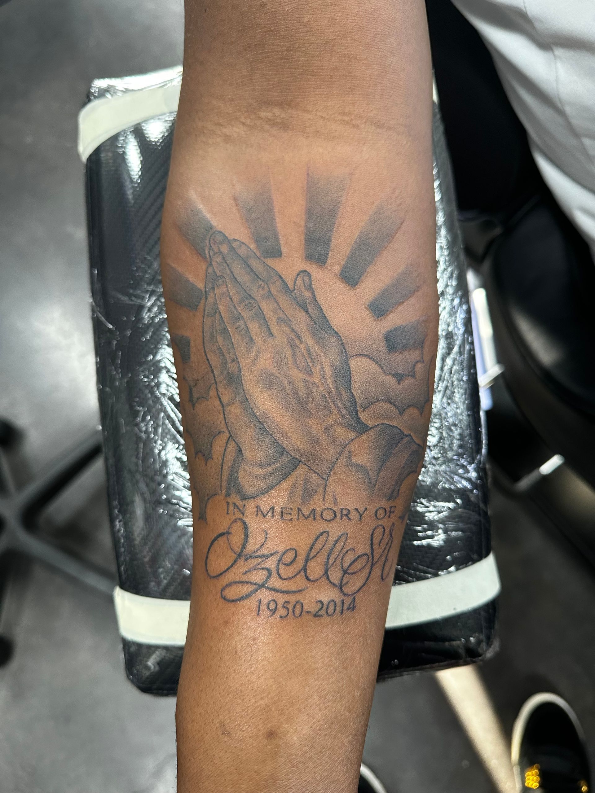 A tattoo on a man 's arm that says 