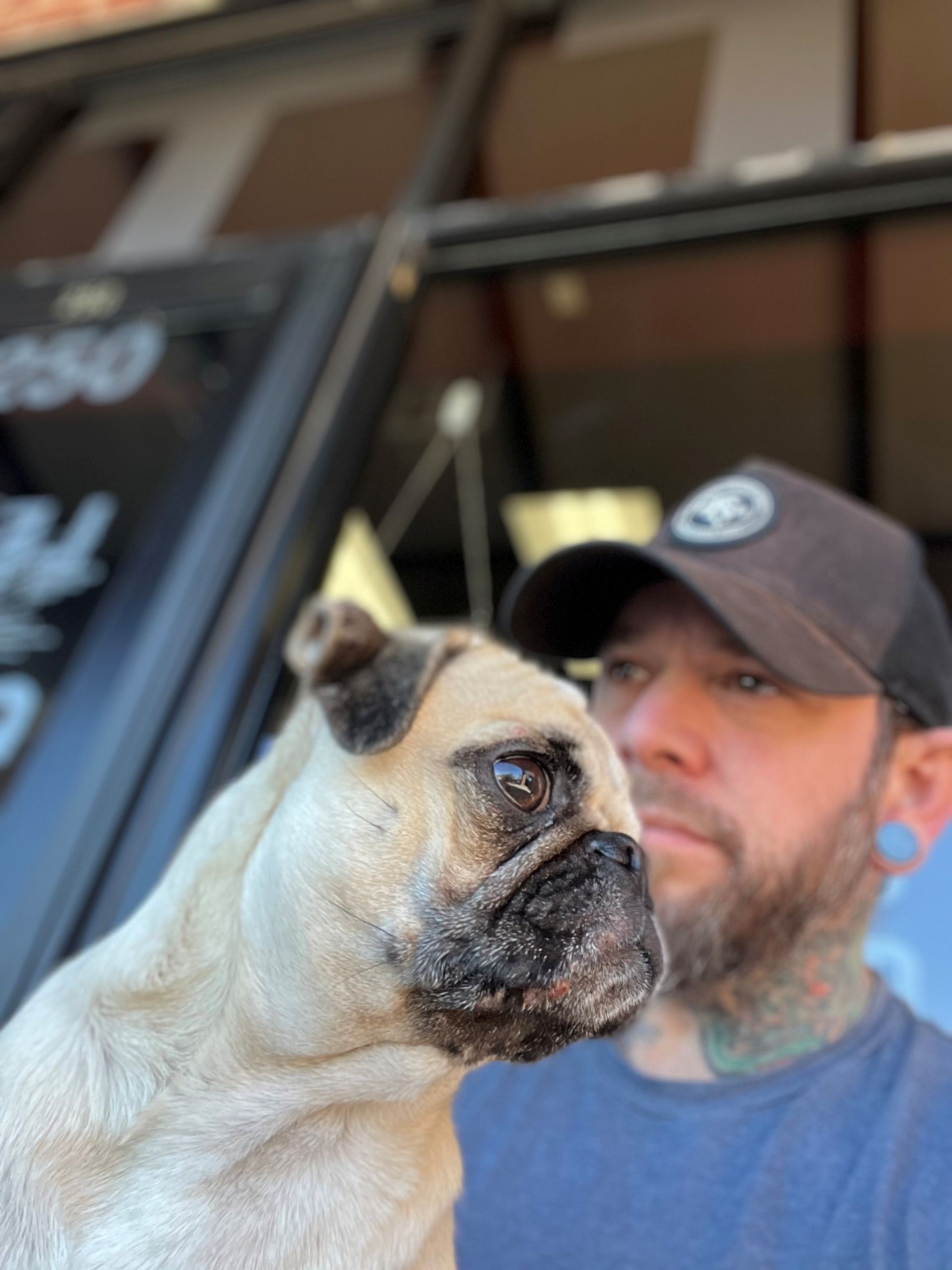 Marc, a tattoo artist with his dog pug.