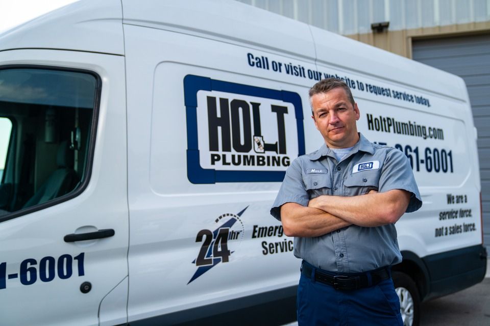 A Holt Plumbing Company LLC's plumbing crew standing beside a service van