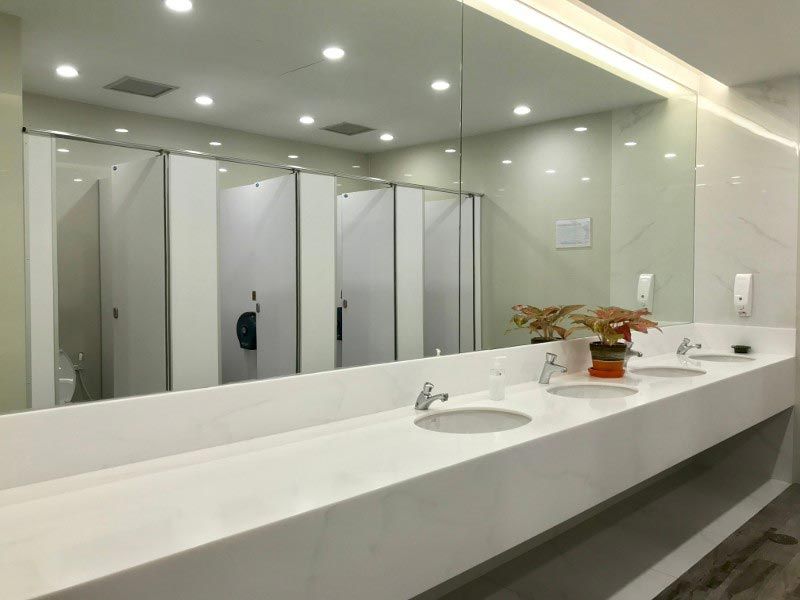 A bathroom with two sinks and a large mirror.
