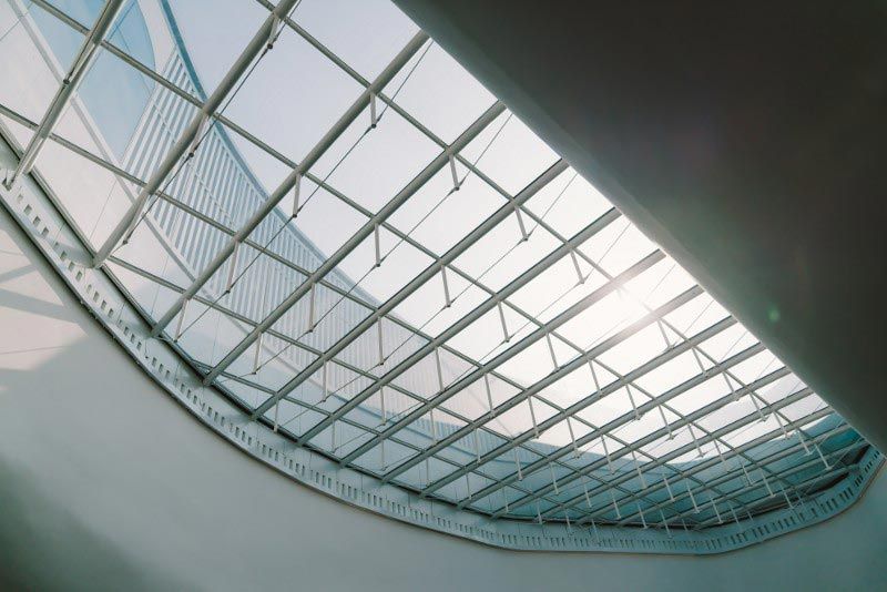 Looking up at the ceiling of a building with a glass roof.