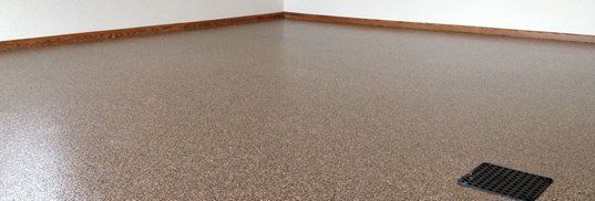 Empty carpeted room with beige walls and a floor vent near the corner