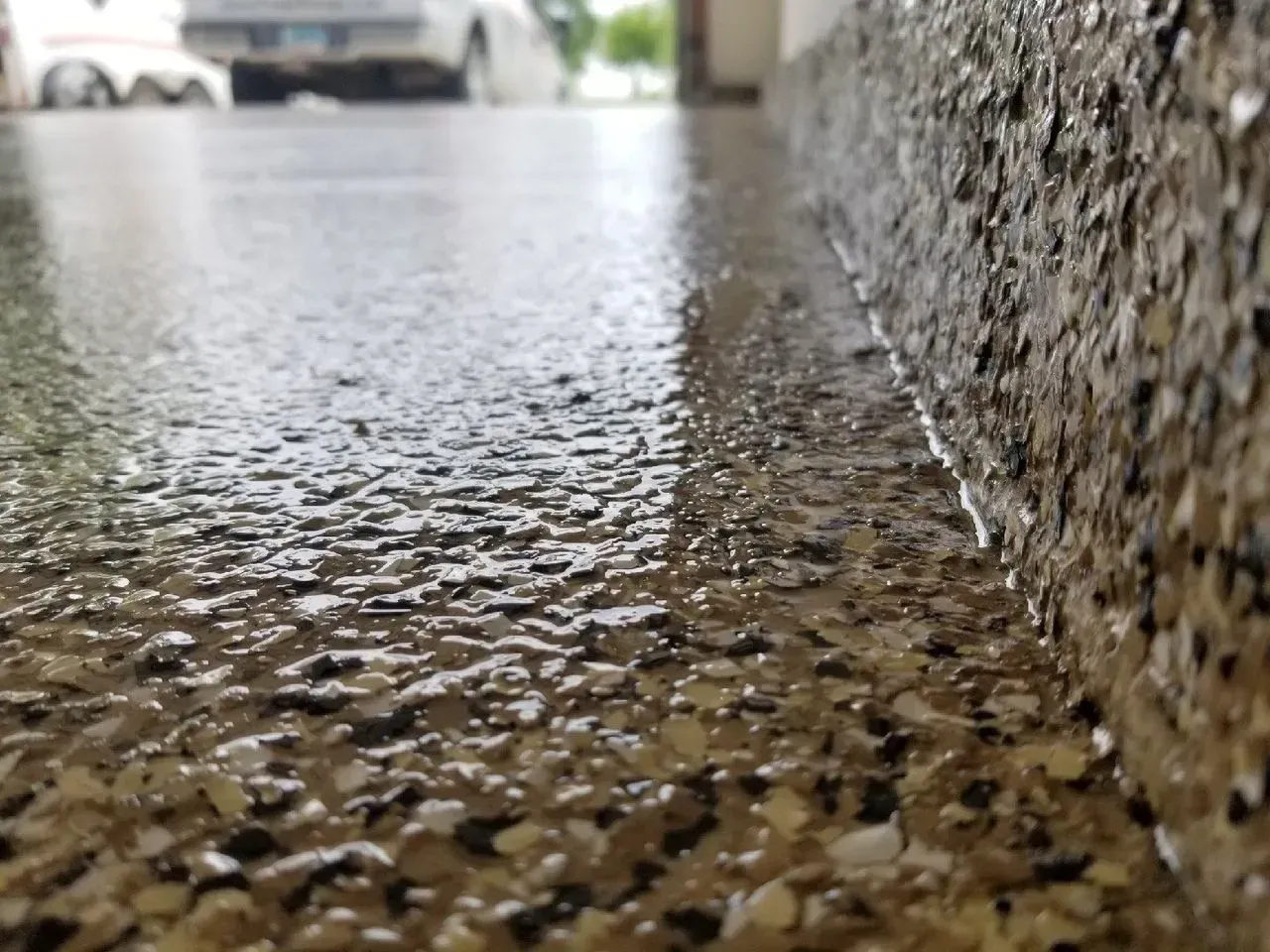 Close-up of rippling water flowing over a textured stone surface outdoors