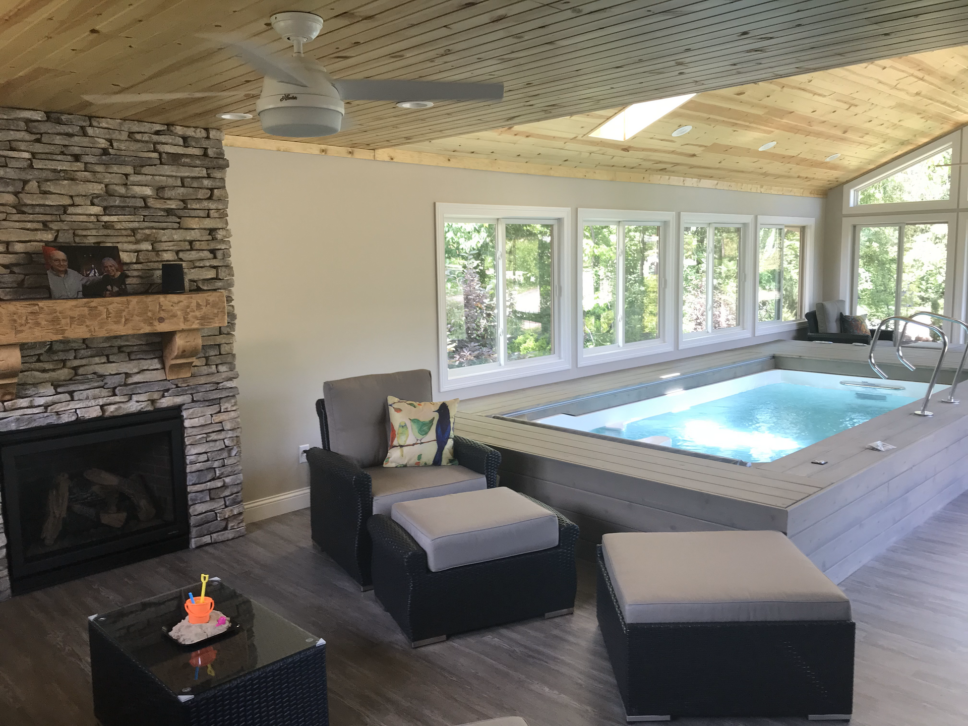 A living room with a hot tub and a fireplace.