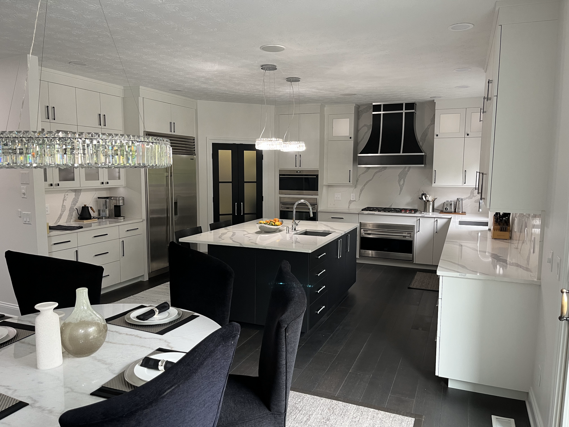 A kitchen with a dining table and chairs in it