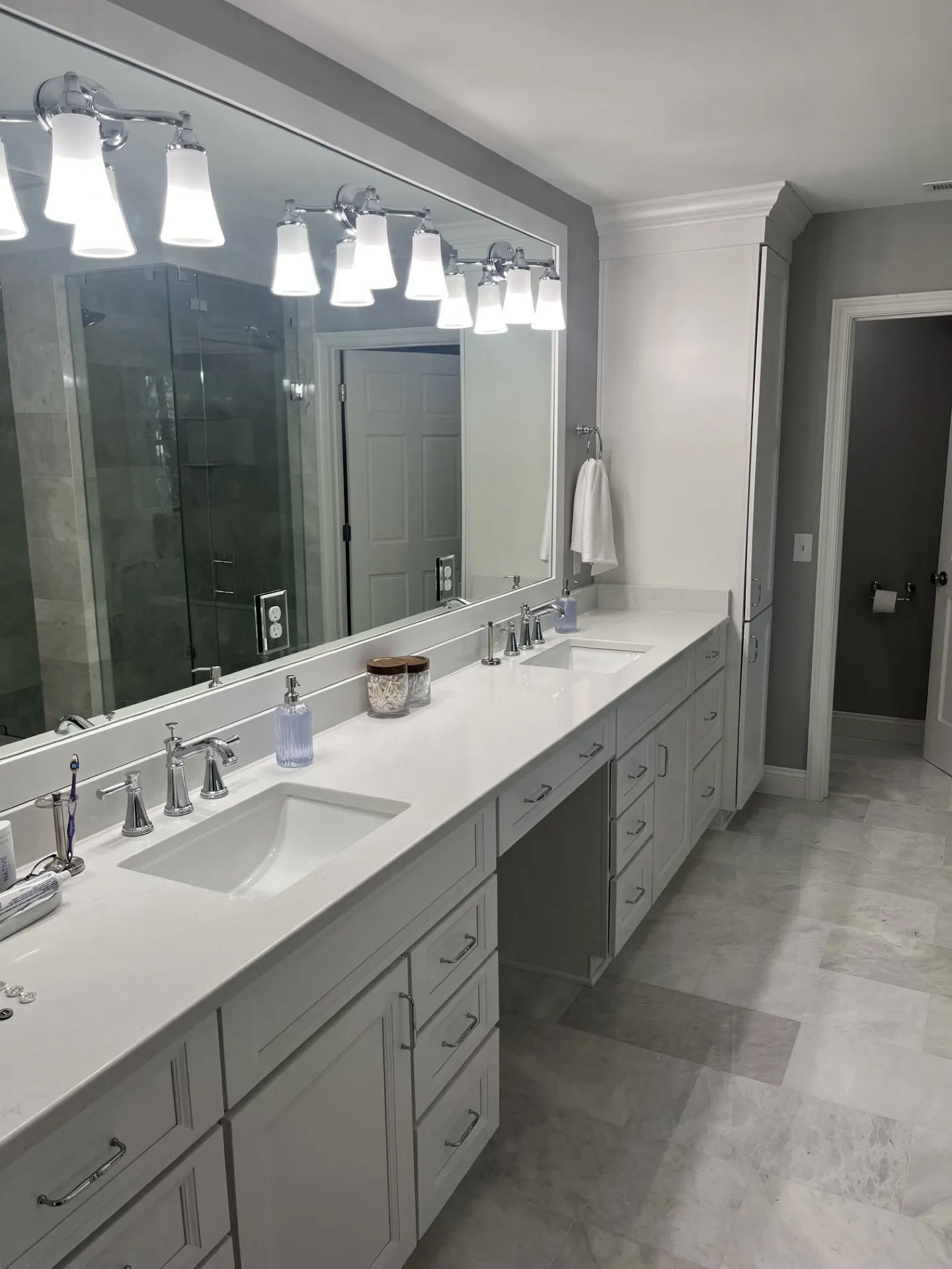 A bathroom with two sinks and a large mirror.