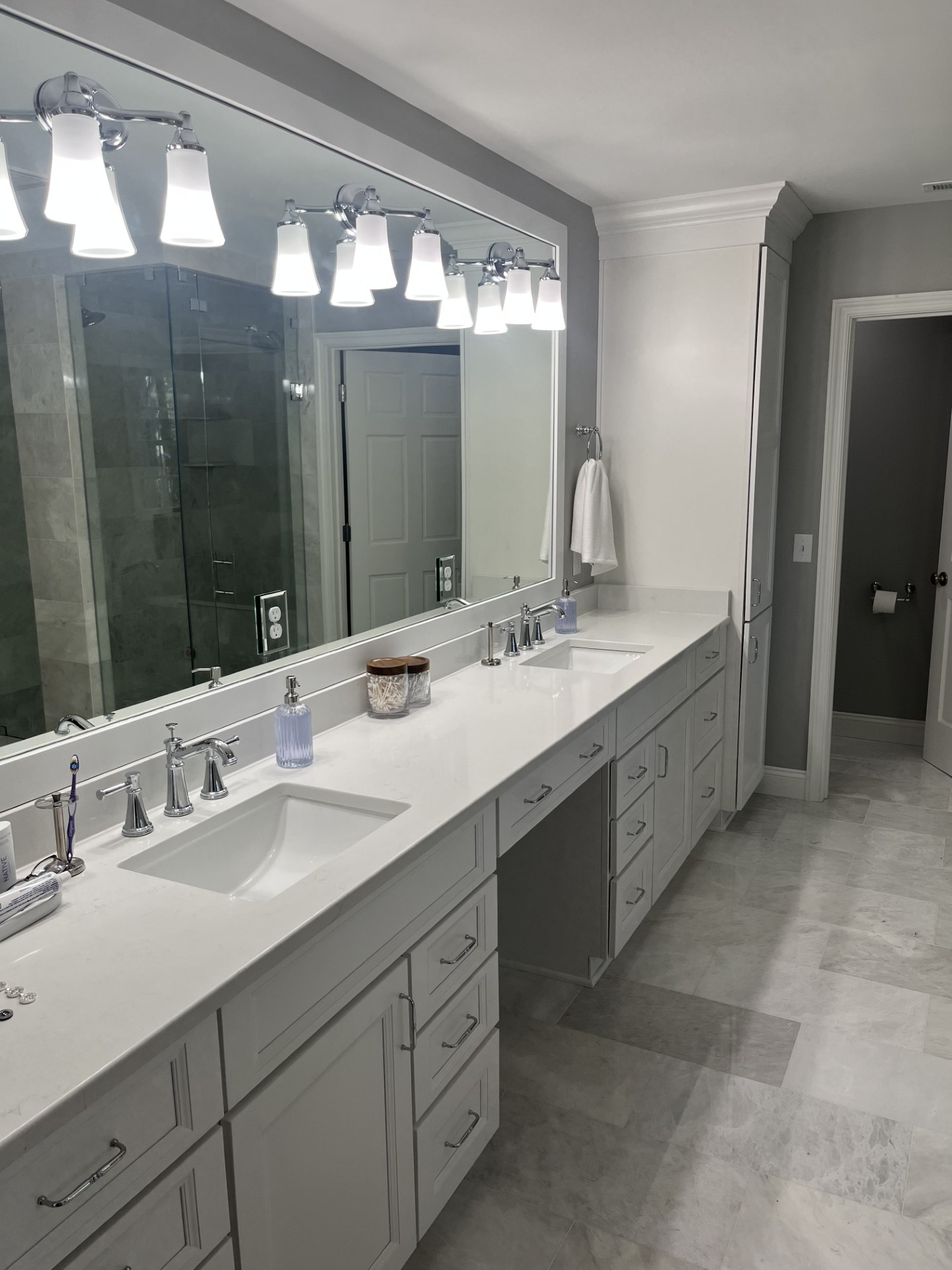 A bathroom with two sinks and a large mirror.