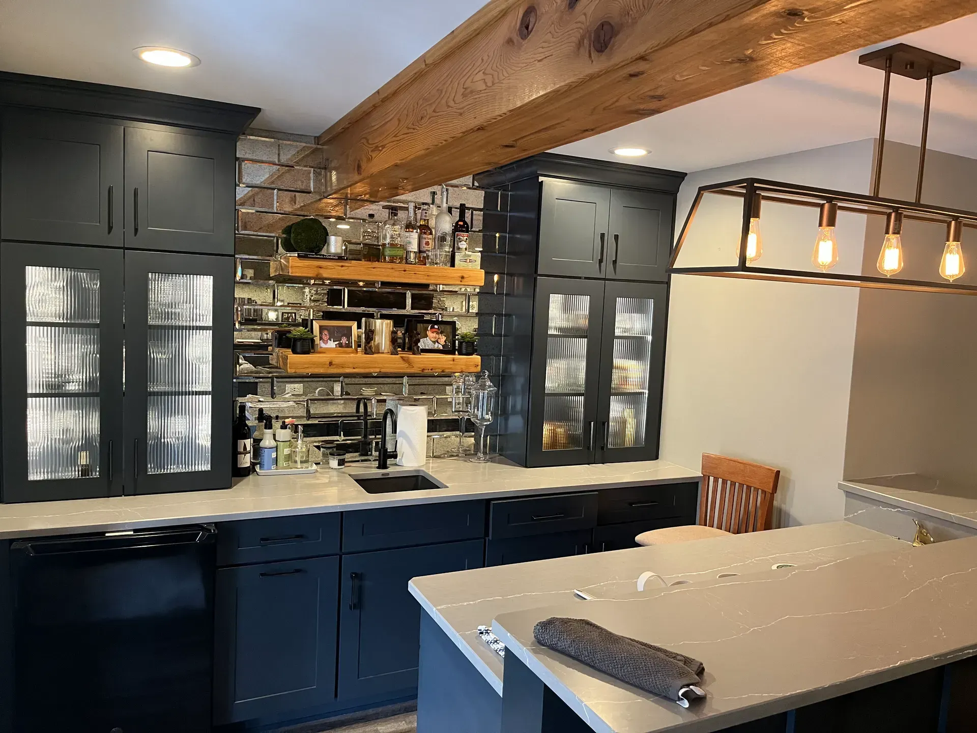 A kitchen with a large island and a sink.