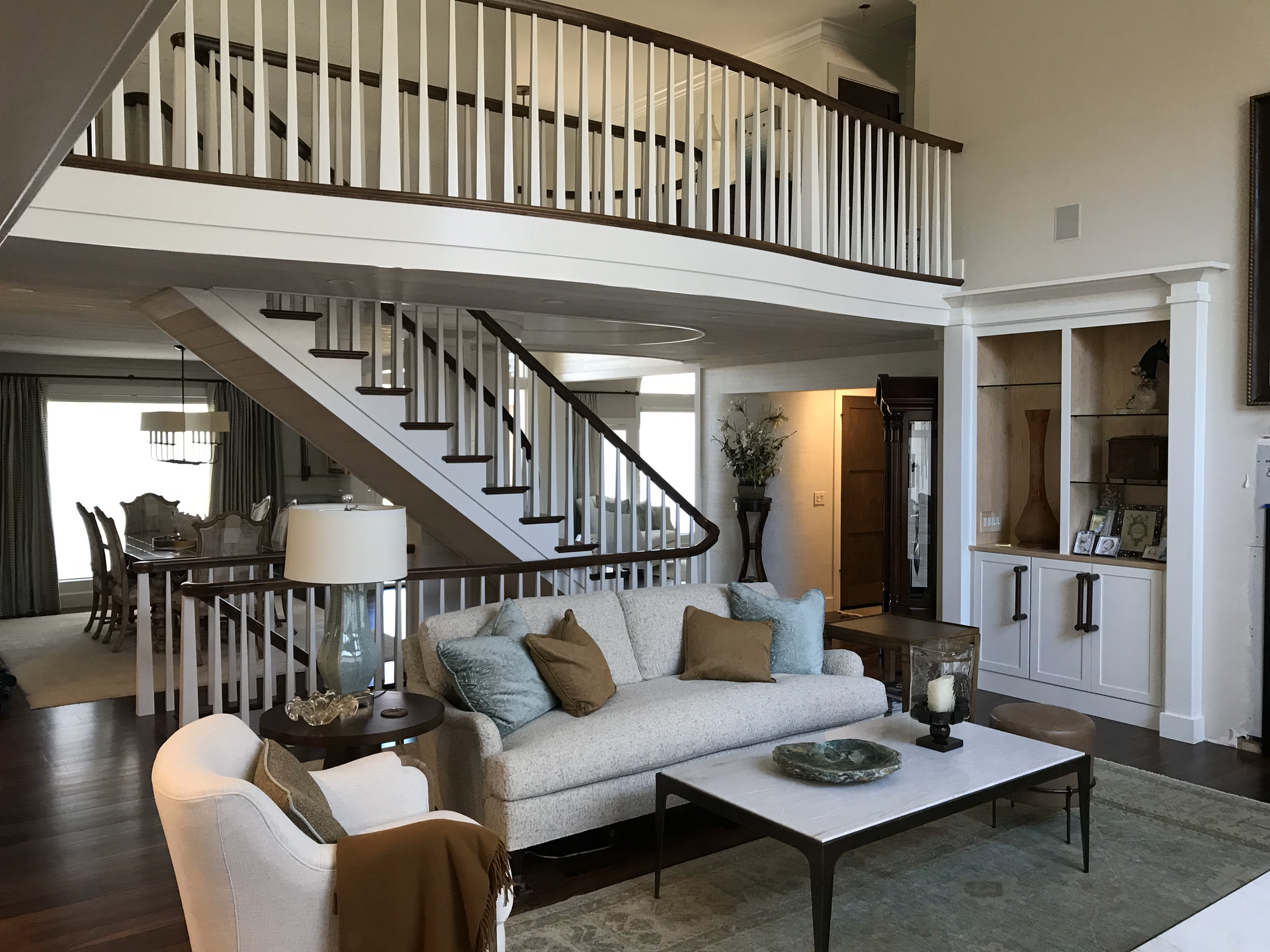 A living room with a couch and stairs in the background