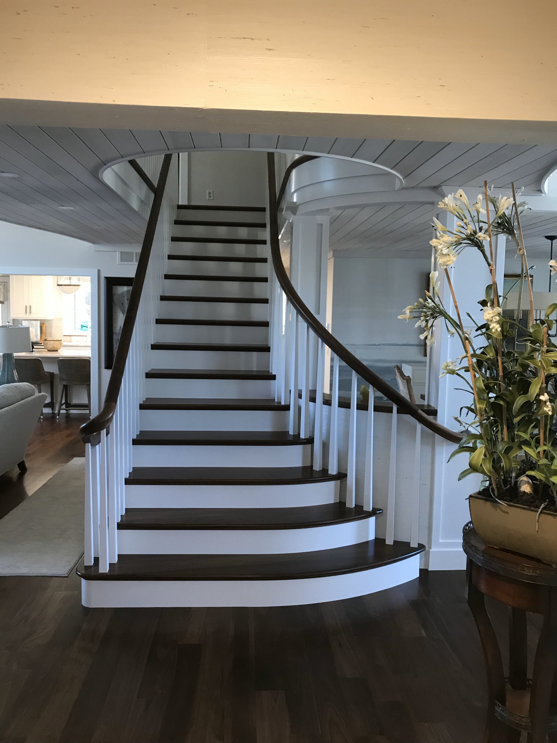 A spiral staircase in a house with a white railing