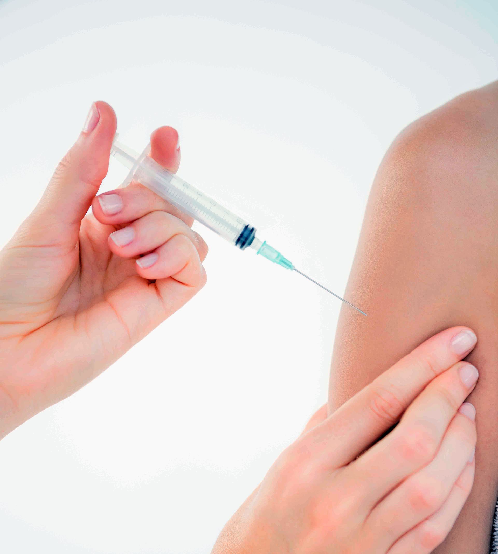 Person receiving a vaccine injection in their arm.