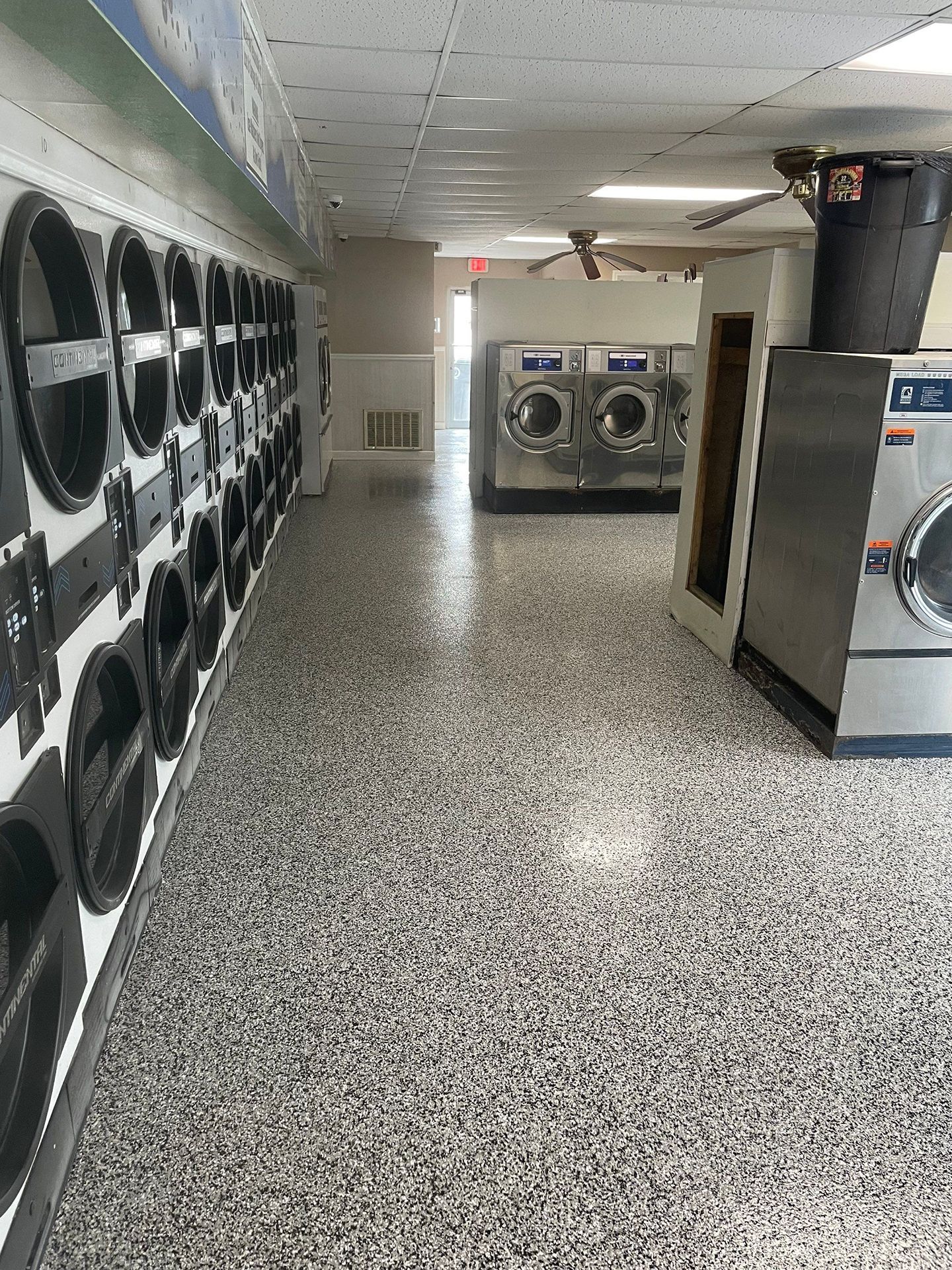 A laundromat filled with lots of washing machines and dryers