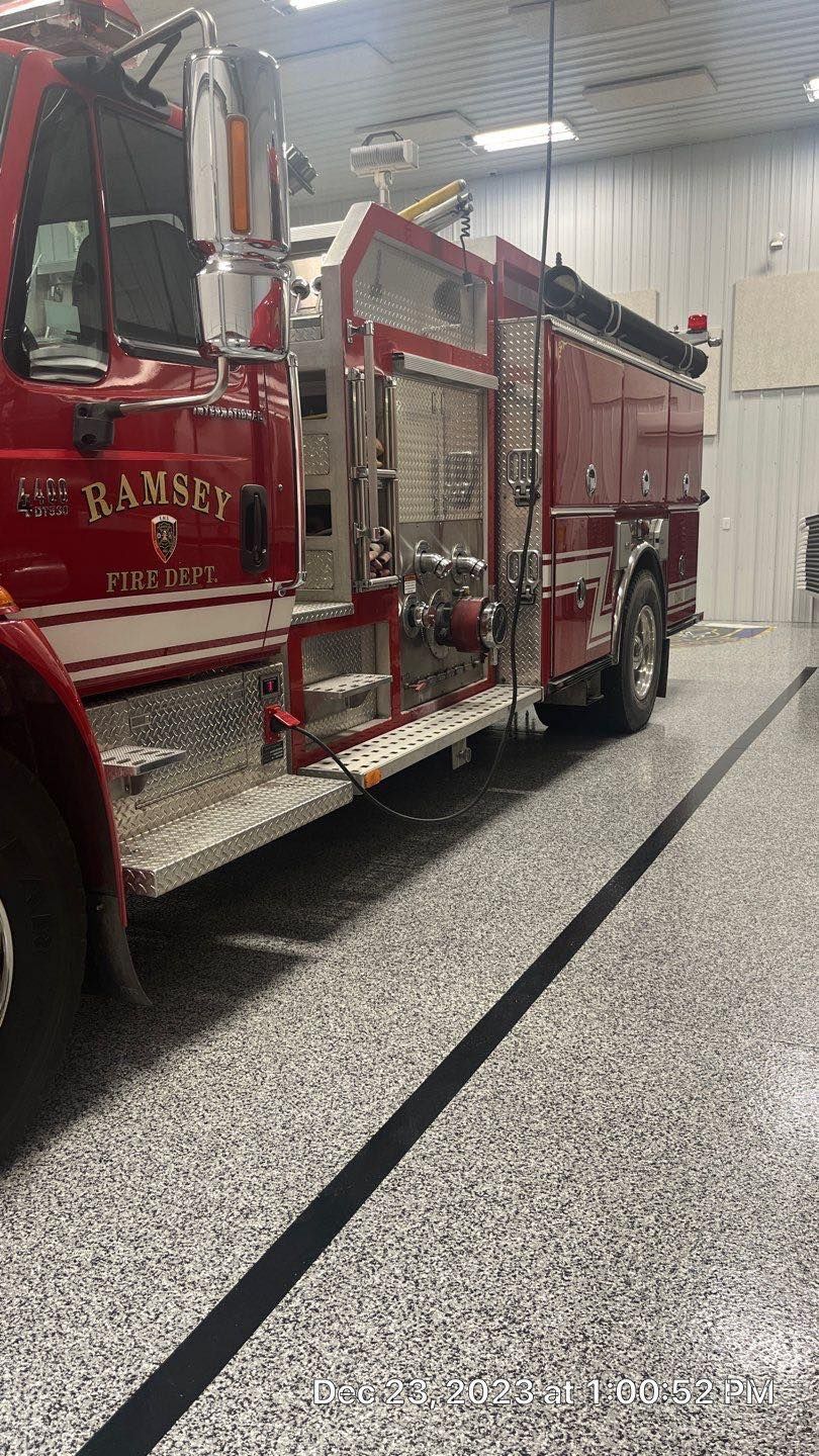 A red fire truck is parked in a garage