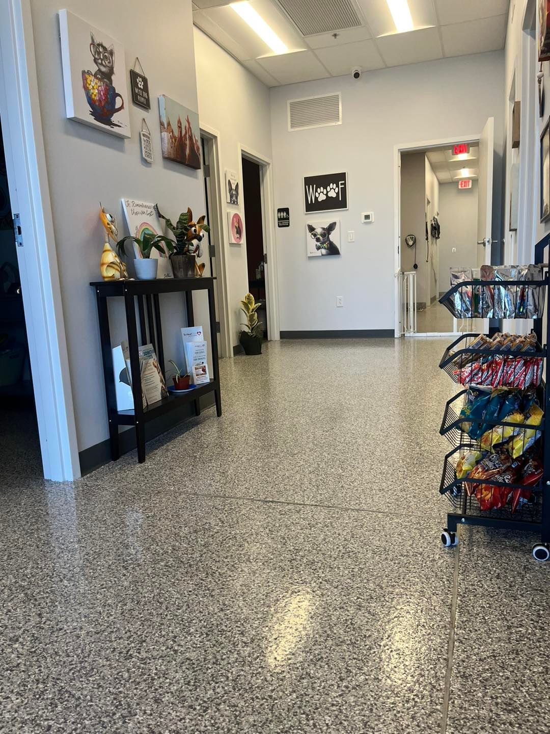A hallway with a table and a bunch of bags on the floor