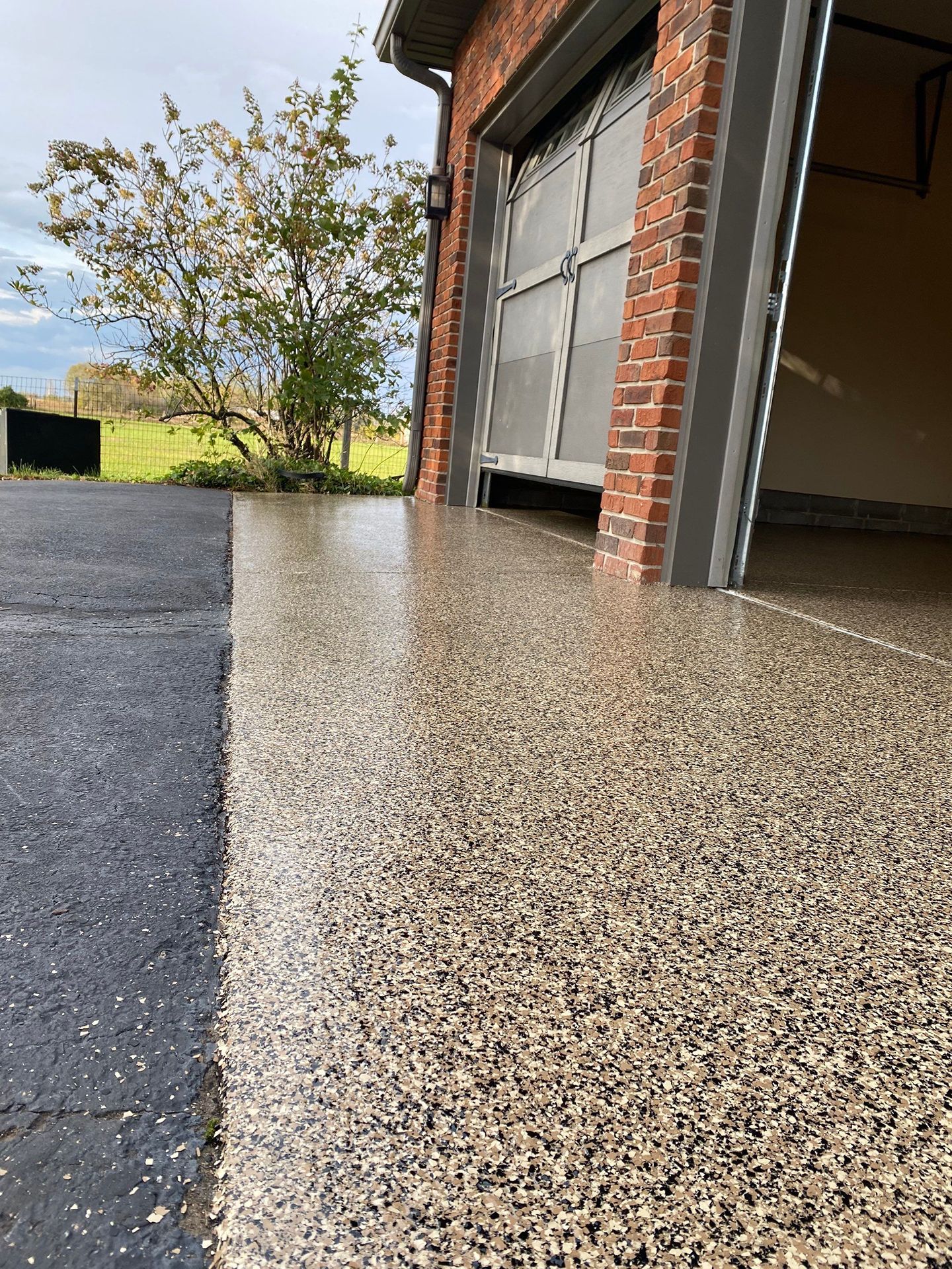 A close up of a garage floor with a brick building in the background