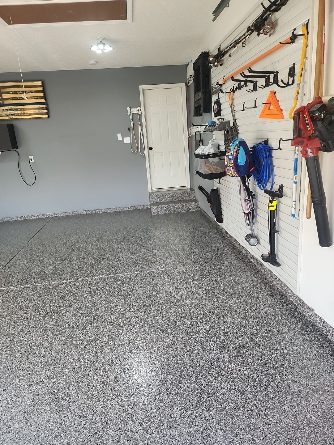 A garage with a lot of tools hanging on the wall