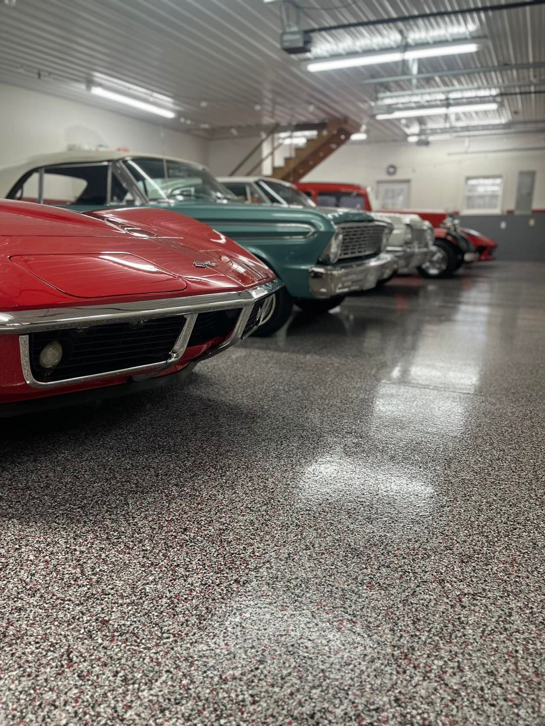 A row of cars are parked in a garage