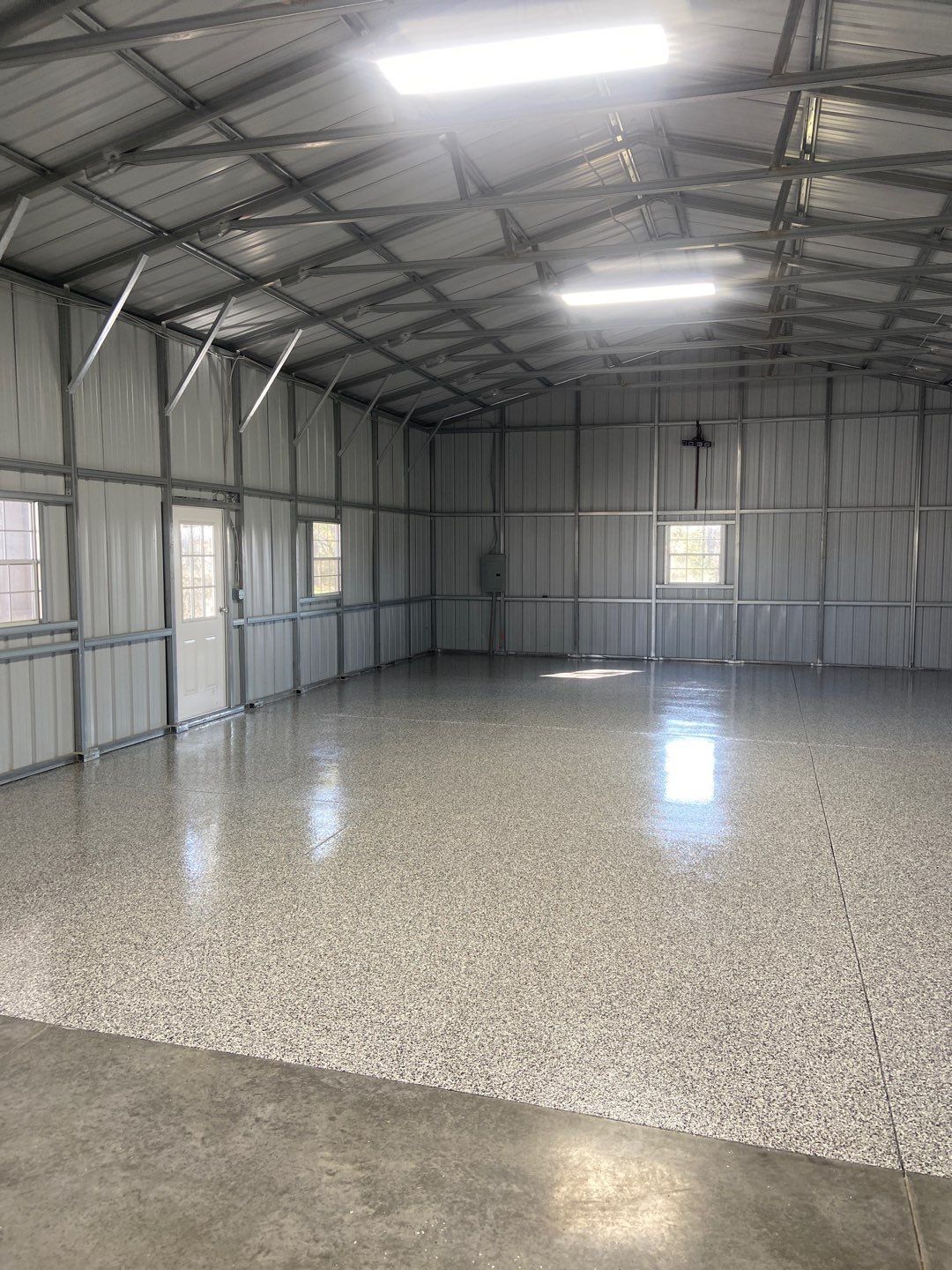 A large empty building with a concrete floor and ceiling