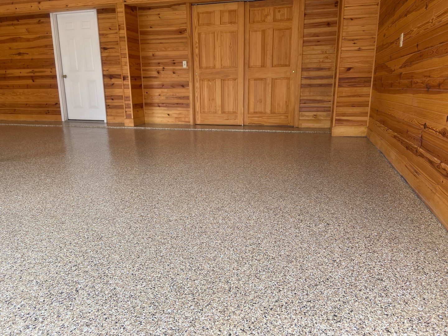 A garage with a concrete floor and wooden walls