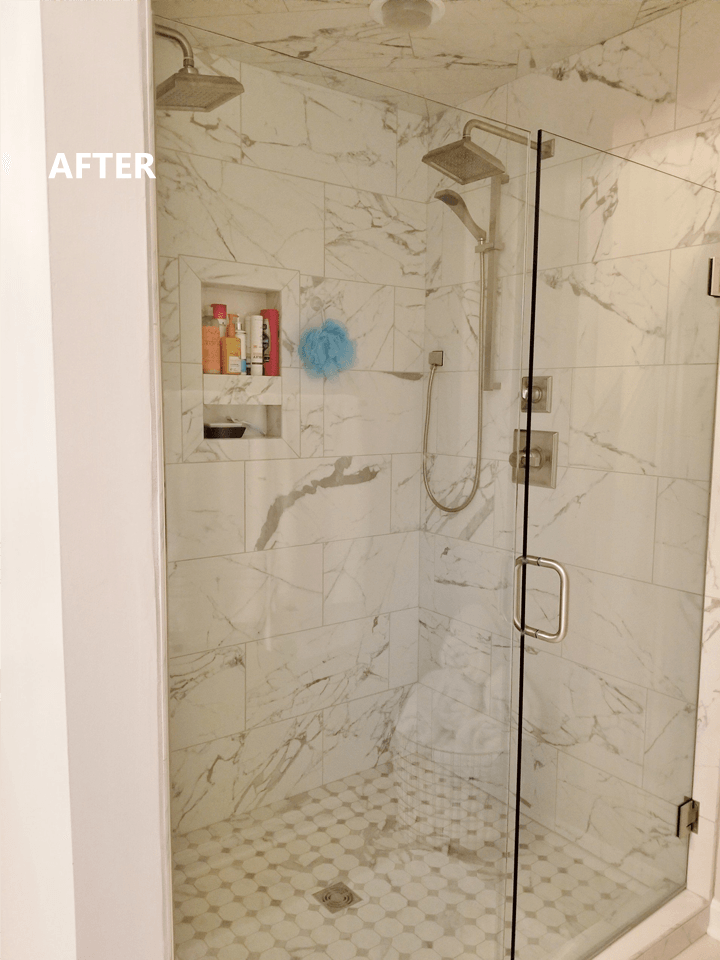 Modern white marble tiled shower with glass door.