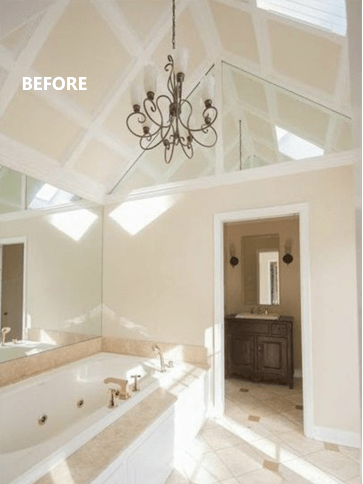 Bathroom with tub, chandelier, mirrored ceiling, and vanity. 