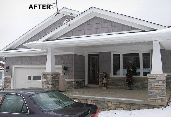 Updated house exterior with gray siding, white trim, and stone accents. Winter setting with snow and a car.