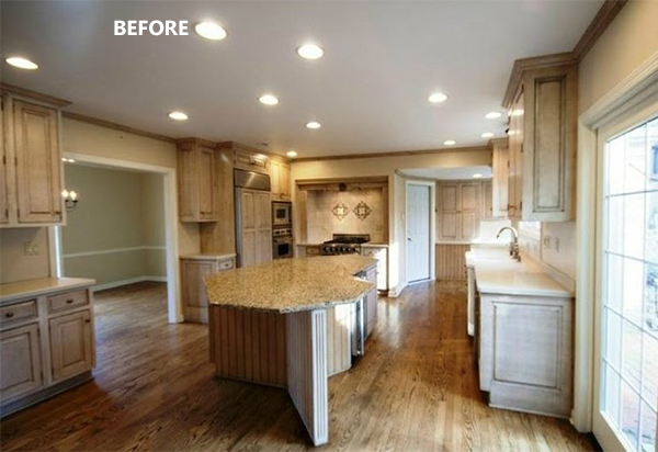 Kitchen with light wood cabinets, granite island, hardwood floors. Before remodel.