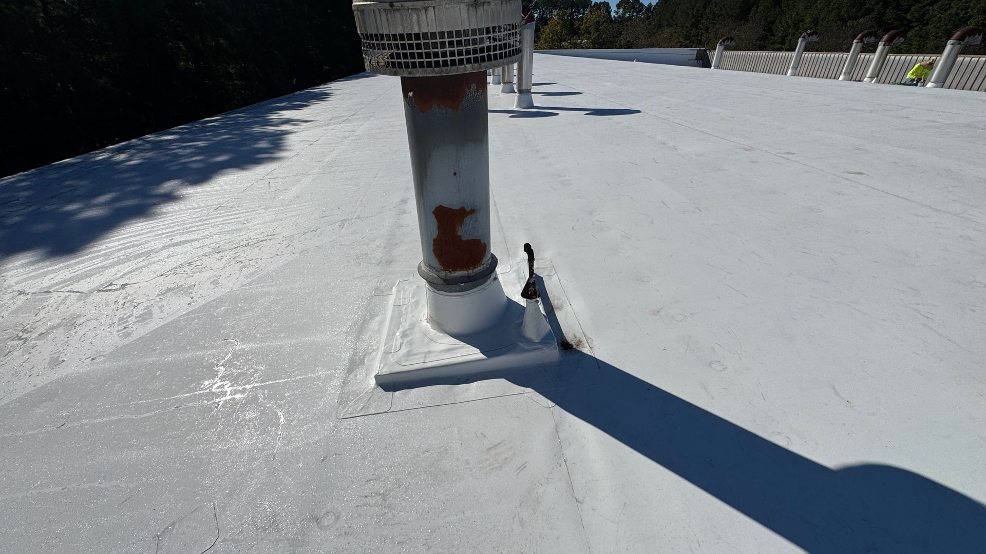 White-coated flat roof with a pipe.