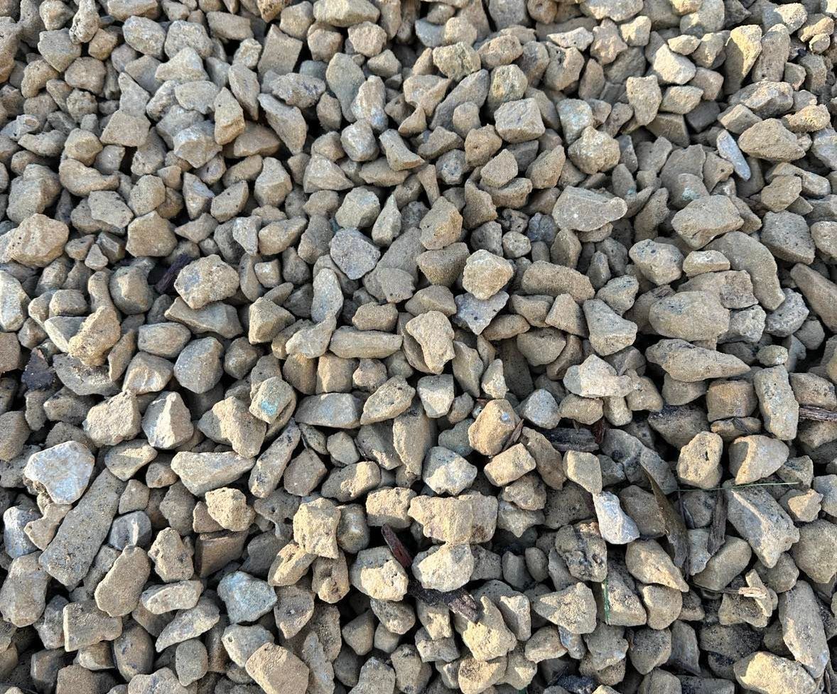 a pile of gravel is sitting on the ground .