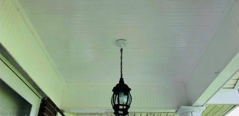 White porch ceiling with a hanging lantern.