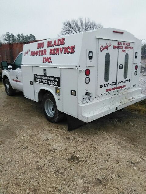 A white van that says Big Blade Plumbing & Rooter, Inc. on it