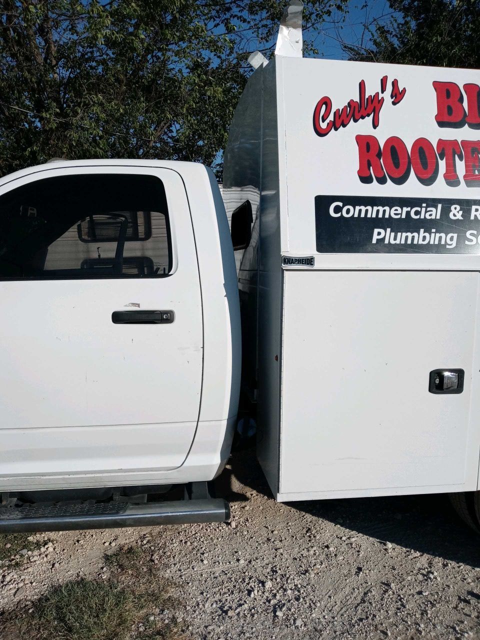 A white service truck of Big Blade Plumbing & Rooter, Inc.