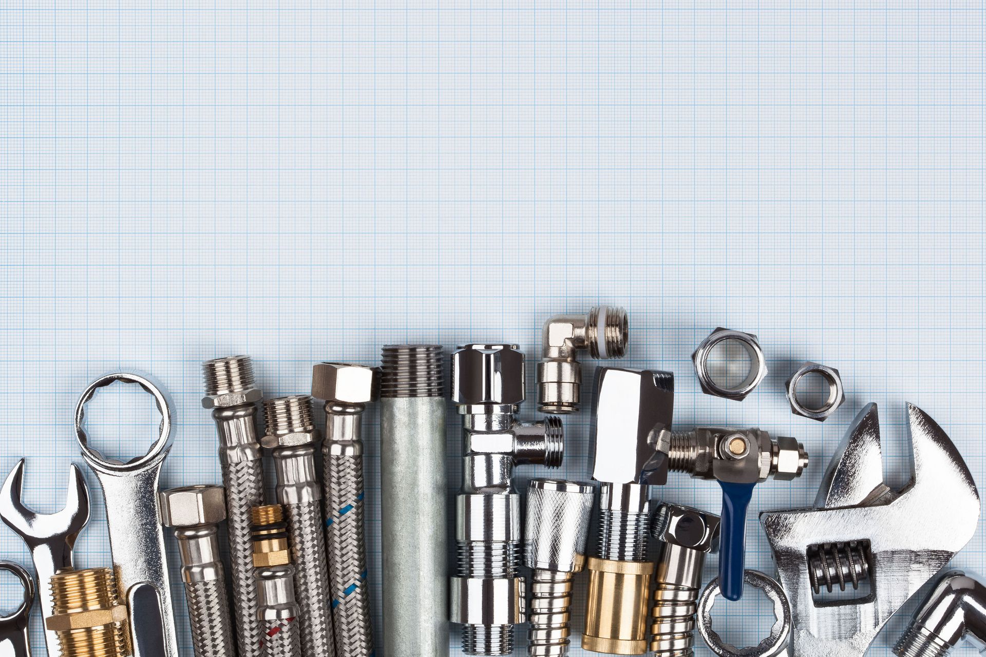 A bunch of plumbing tools are laying on a table.