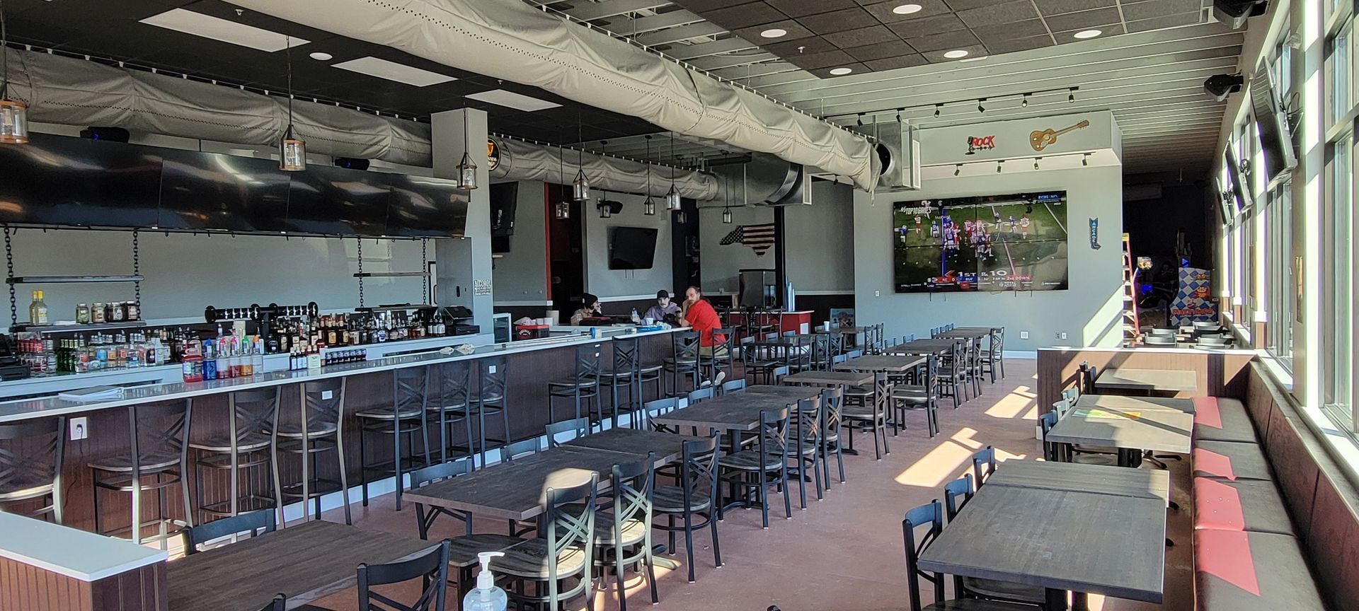 a large dining room with tables and chairs and a bar