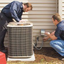 Two men installing an air conditioning unit