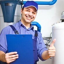 Man standing in front of a water heater