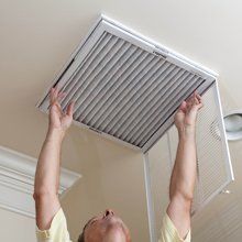 Man installing a vent in the ceiling