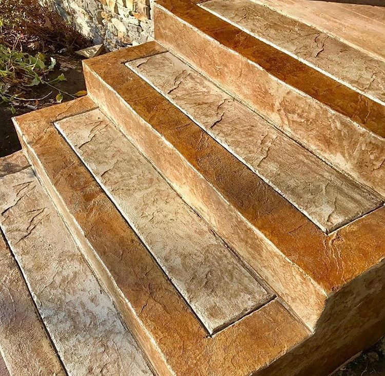 Sunlit stone steps with warm brown and tan tiles outdoors