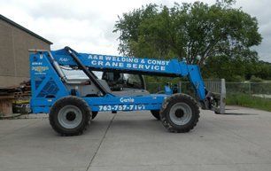 Yellow crane inside a building, with a raised boom.