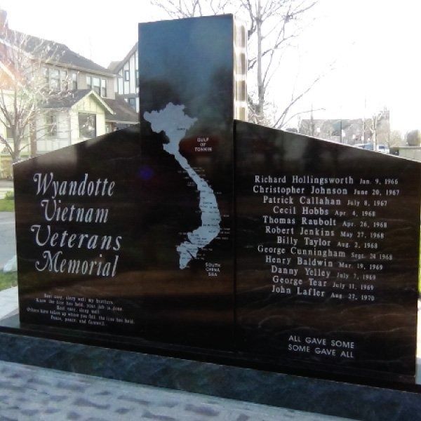 Vietnam Veterans Memorial with list of names and map outline of Vietnam.
