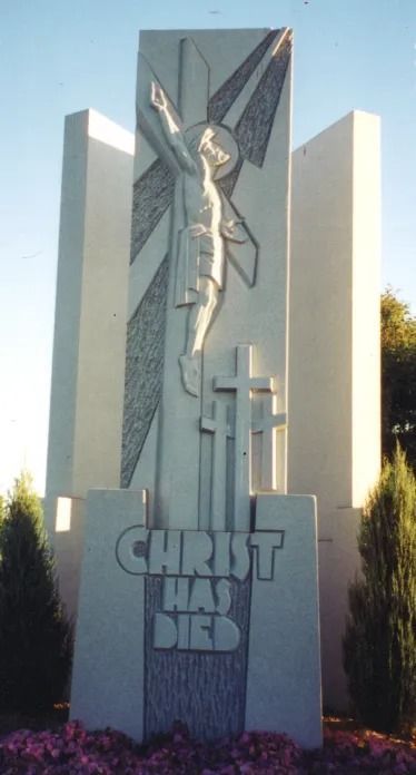 Monument with a carved depiction of Jesus on the cross and the text 