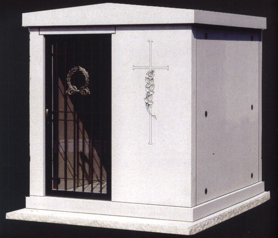Concrete mausoleum with wrought-iron door, cross carving, and wreath.